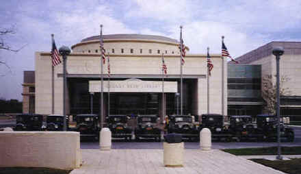 Model A Fords in front of the George Bush Library